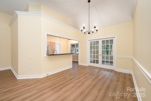 975 Pine Knoll Rd, Fort Mill, SC 29715 - unfurnished dining area with french doors, a chandelier, wood finished floors, and lofted ceiling