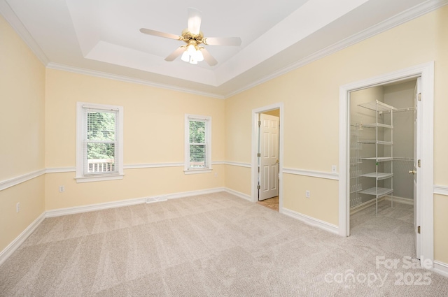 975 Pine Knoll Rd, Fort Mill, SC 29715 - unfurnished bedroom featuring carpet, a raised ceiling, a walk in closet, crown molding, and a ceiling fan