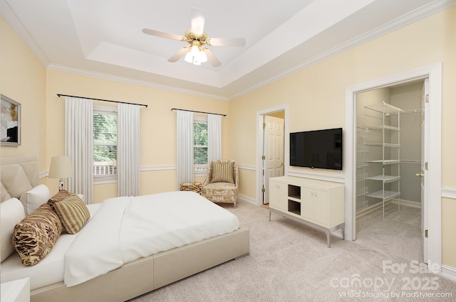 975 Pine Knoll Rd, Fort Mill, SC 29715 - bedroom featuring a raised ceiling, ornamental molding, light colored carpet, a walk in closet, and a ceiling fan
