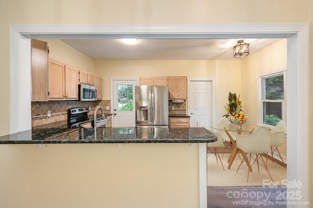 975 Pine Knoll Rd, Fort Mill, SC 29715 - kitchen featuring appliances with stainless steel finishes, a peninsula, backsplash, and dark stone counters