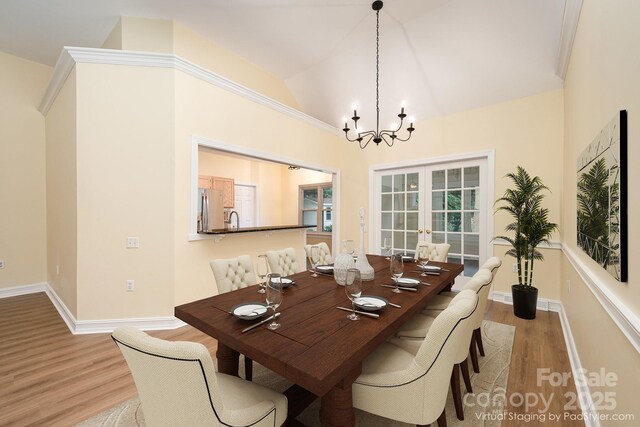975 Pine Knoll Rd, Fort Mill, SC 29715 - dining area featuring wood finished floors, lofted ceiling, a chandelier, and french doors