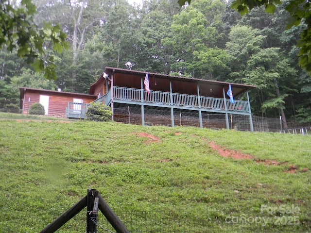 1425 Sorrells Cove Rd, Clyde, NC 28721 - rear view of house with a lawn and a wooden deck