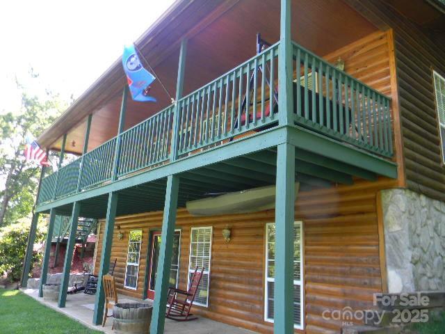1425 Sorrells Cove Rd, Clyde, NC 28721 - rear view of house featuring faux log siding and a patio