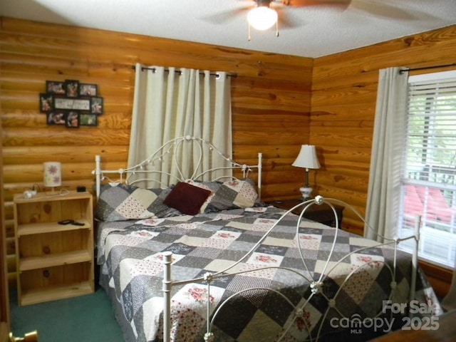 1425 Sorrells Cove Rd, Clyde, NC 28721 - bedroom featuring log walls and a ceiling fan