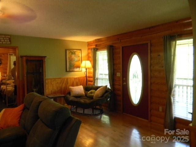 1425 Sorrells Cove Rd, Clyde, NC 28721 - entrance foyer with log walls, wood finished floors, and wainscoting