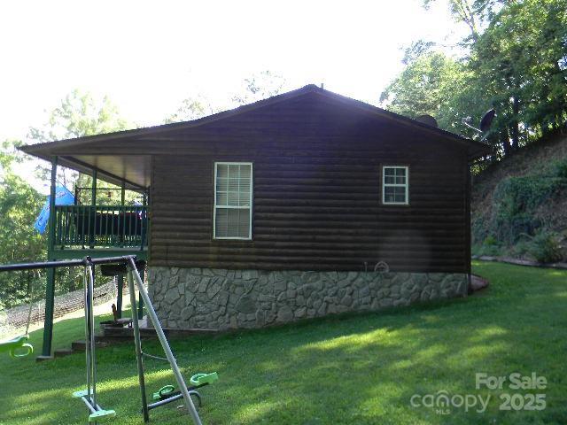 1425 Sorrells Cove Rd, Clyde, NC 28721 - view of property exterior featuring a yard and faux log siding
