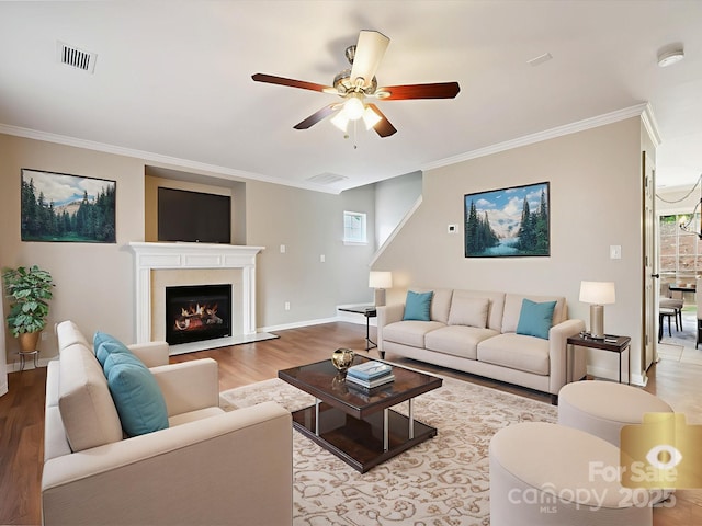 3830 Brookchase Ln, Charlotte, NC 28205 - living room with light wood-style flooring, ceiling fan, crown molding, plenty of natural light, and a warm lit fireplace