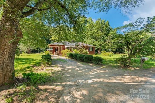 25 Wall Rd, Tryon, NC 28782 - ranch-style house with dirt driveway and a front lawn