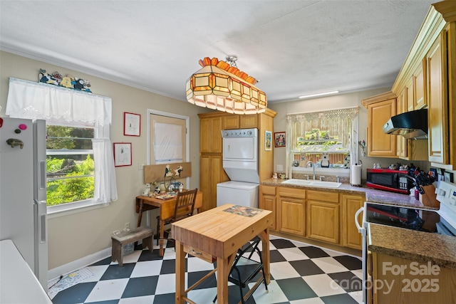 25 Wall Rd, Tryon, NC 28782 - kitchen with light floors, stacked washer / drying machine, extractor fan, white fridge with ice dispenser, and range with electric cooktop