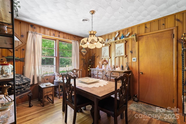 25 Wall Rd, Tryon, NC 28782 - dining area featuring wooden walls, light wood-style flooring, and a chandelier