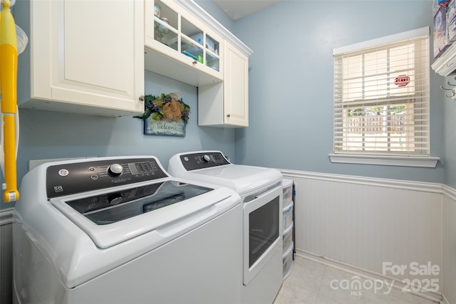 6422 Gatesville Ln, Charlotte, NC 28270 - washroom featuring washing machine and clothes dryer, cabinet space, and a wainscoted wall