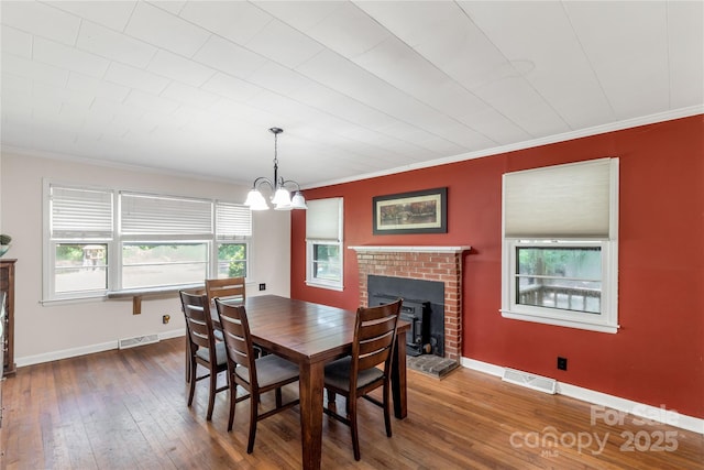 6115 Campbell Rd, York, SC 29745 - dining room with crown molding, hardwood / wood-style flooring, and a chandelier