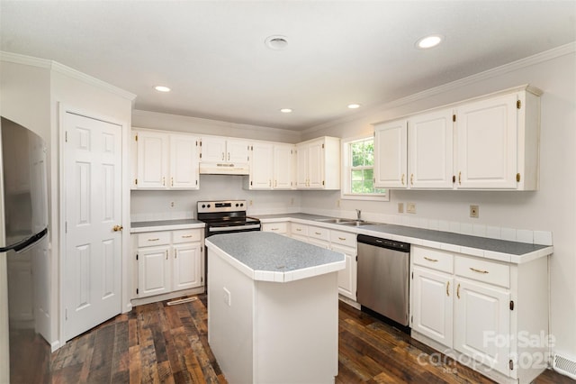 508 Bridgestone Ln, Rock Hill, SC 29730 - kitchen with stainless steel appliances, under cabinet range hood, crown molding, dark wood finished floors, and white cabinetry