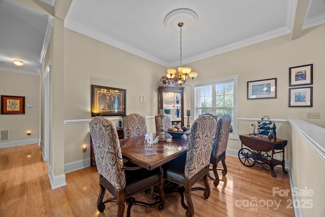 1006 Pin Oak Trl Unit 5, Hendersonville, NC 28739 - dining room featuring light wood finished floors, a chandelier, and ornamental molding