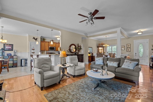 1006 Pin Oak Trl Unit 5, Hendersonville, NC 28739 - living room featuring a chandelier, ceiling fan, ornamental molding, and light wood finished floors