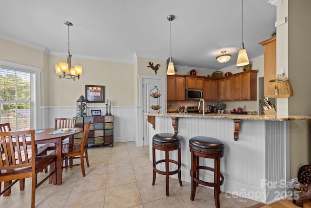 1006 Pin Oak Trl Unit 5, Hendersonville, NC 28739 - kitchen featuring stainless steel microwave, crown molding, a peninsula, light stone counters, and a chandelier