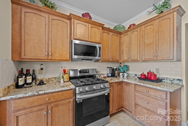 1006 Pin Oak Trl Unit 5, Hendersonville, NC 28739 - kitchen with stainless steel appliances, ornamental molding, light stone countertops, backsplash, and light tile patterned floors