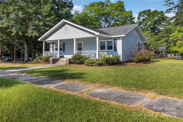 202 Gum St, Pageland, SC 29728 - view of front of property with covered porch, a front lawn, and roof with shingles