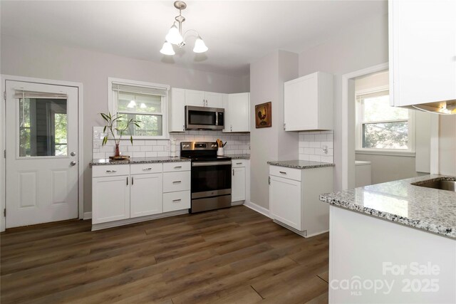 202 Gum St, Pageland, SC 29728 - kitchen featuring appliances with stainless steel finishes, tasteful backsplash, white cabinetry, light stone counters, and dark wood finished floors