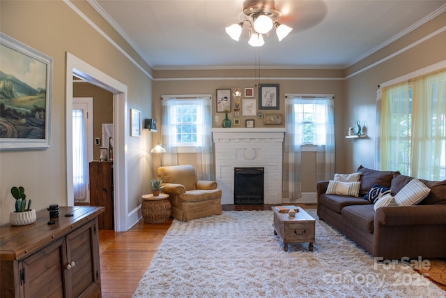 102 Cuthberson St, Morganton, NC 28655 - living area featuring ceiling fan, plenty of natural light, wood finished floors, ornamental molding, and a brick fireplace