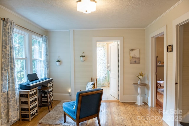 102 Cuthberson St, Morganton, NC 28655 - sitting room with crown molding, light wood finished floors, a textured ceiling, and a desk