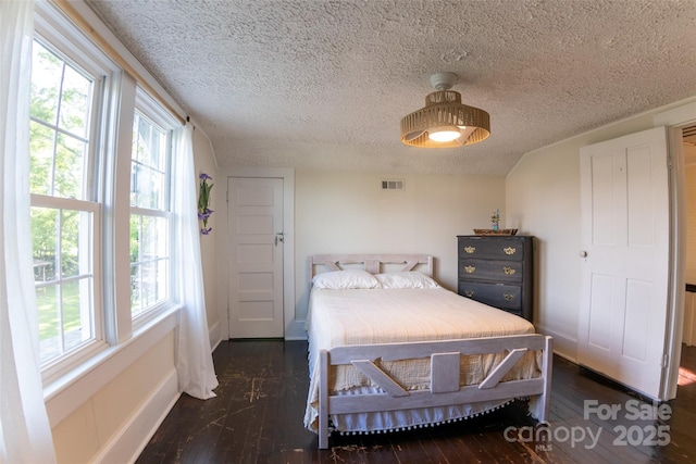 102 Cuthberson St, Morganton, NC 28655 - bedroom with wood-type flooring, a textured ceiling, and multiple windows