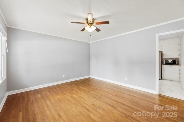 814 W Gold St, Kings Mountain, NC 28086 - spare room with a ceiling fan, ornamental molding, and light wood-style flooring