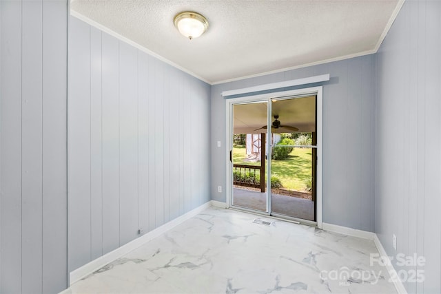 814 W Gold St, Kings Mountain, NC 28086 - empty room with ornamental molding, marble finish flooring, a textured ceiling, and wooden walls