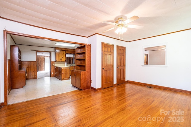 3954 E Burke Blvd, Connelly Springs, NC 28612 - unfurnished living room featuring light wood-type flooring, a ceiling fan, and crown molding