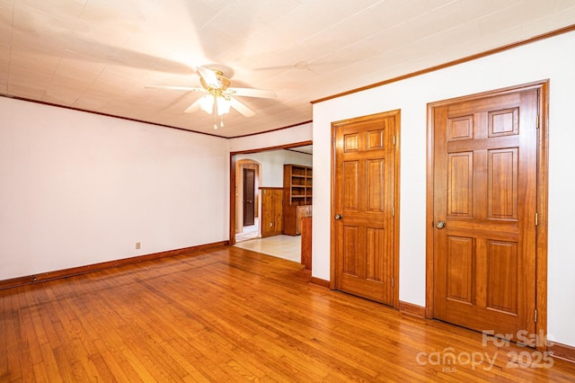 3954 E Burke Blvd, Connelly Springs, NC 28612 - unfurnished room with arched walkways, ceiling fan, light wood-type flooring, and crown molding