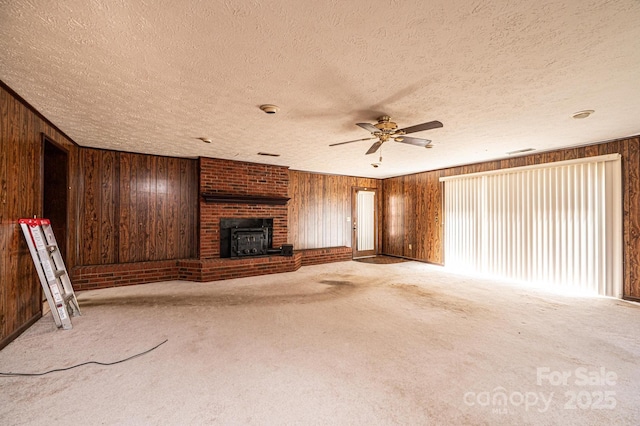 3954 E Burke Blvd, Connelly Springs, NC 28612 - unfurnished living room with wood walls, a textured ceiling, ceiling fan, and carpet floors