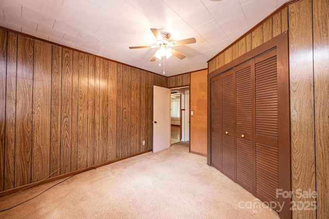 3954 E Burke Blvd, Connelly Springs, NC 28612 - unfurnished bedroom featuring carpet floors, a closet, wooden walls, and ceiling fan