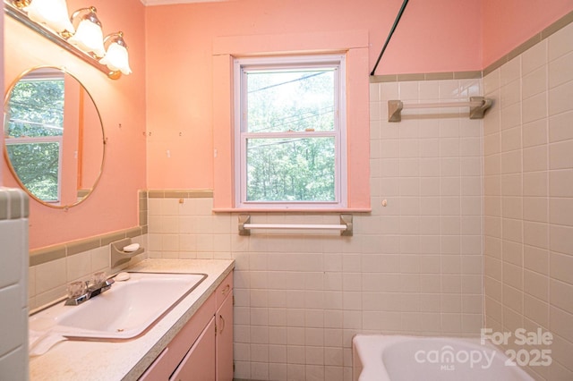 3954 E Burke Blvd, Connelly Springs, NC 28612 - full bath featuring tile walls, a tub to relax in, vanity, plenty of natural light, and wainscoting