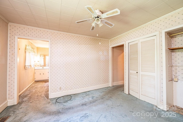 3954 E Burke Blvd, Connelly Springs, NC 28612 - unfurnished bedroom with crown molding, carpet flooring, a ceiling fan, wallpapered walls, and a closet