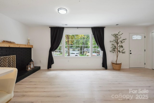5420 Gwynne Ave, Charlotte, NC 28205 - living room with light wood-type flooring and a fireplace