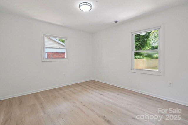 5420 Gwynne Ave, Charlotte, NC 28205 - empty room with plenty of natural light and light wood finished floors