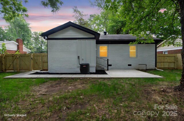 5420 Gwynne Ave, Charlotte, NC 28205 - rear view of property featuring a gate, a patio, brick siding, and crawl space