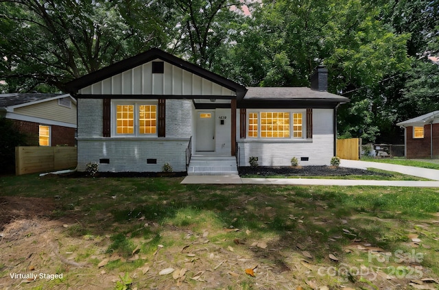 5420 Gwynne Ave, Charlotte, NC 28205 - view of front of house featuring crawl space, a chimney, brick siding, and board and batten siding