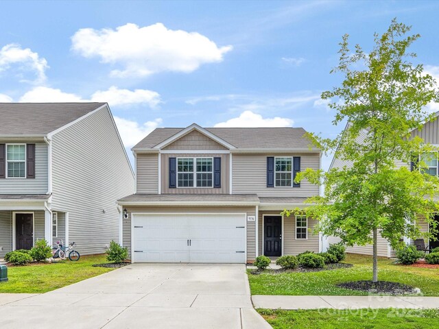 9136 Creedmore Hills Dr, Charlotte, NC 28214 - view of front of property with concrete driveway, an attached garage, and a front lawn