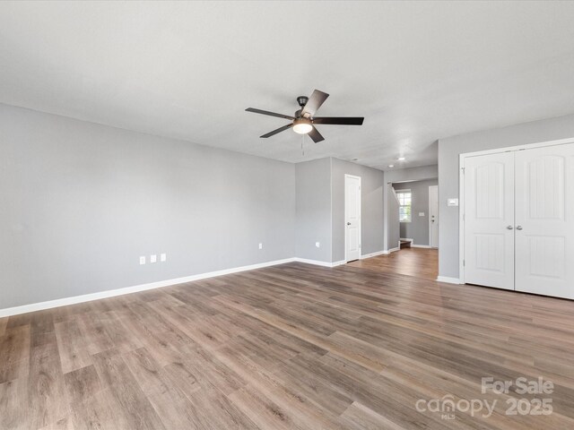 9136 Creedmore Hills Dr, Charlotte, NC 28214 - unfurnished living room with ceiling fan and wood finished floors