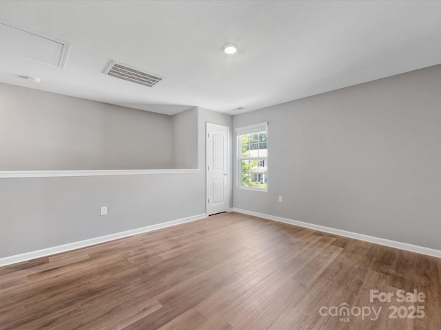 9136 Creedmore Hills Dr, Charlotte, NC 28214 - spare room featuring wood finished floors and attic access
