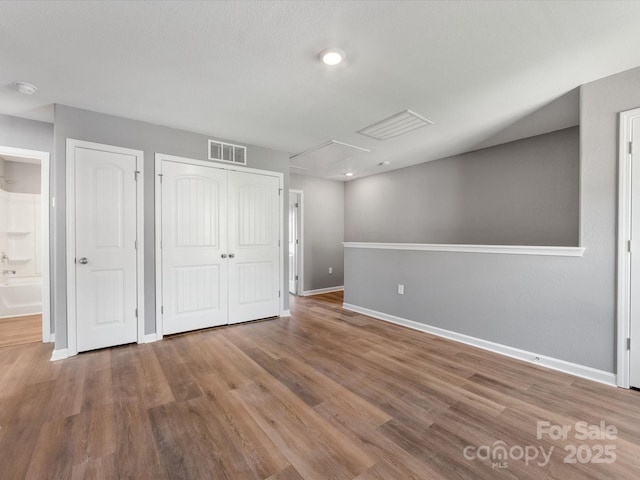 9136 Creedmore Hills Dr, Charlotte, NC 28214 - unfurnished bedroom with attic access, wood finished floors, and ensuite bathroom