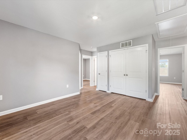 9136 Creedmore Hills Dr, Charlotte, NC 28214 - unfurnished bedroom with attic access and wood finished floors