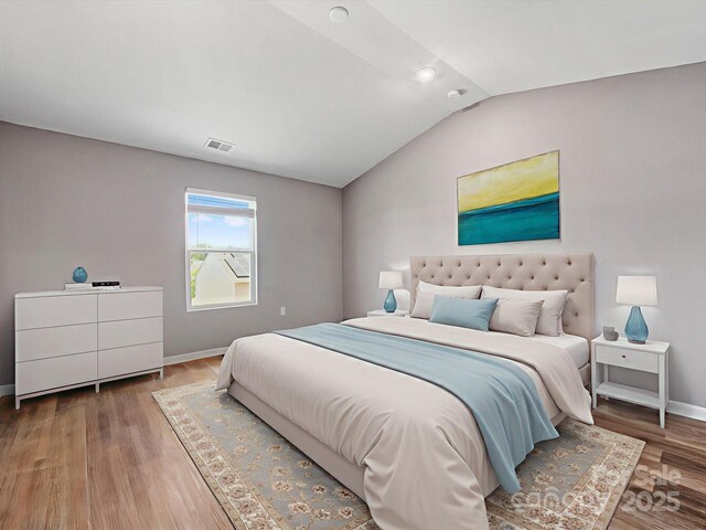 9136 Creedmore Hills Dr, Charlotte, NC 28214 - bedroom with vaulted ceiling and wood finished floors