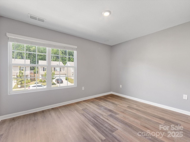 9136 Creedmore Hills Dr, Charlotte, NC 28214 - spare room featuring healthy amount of natural light and wood finished floors