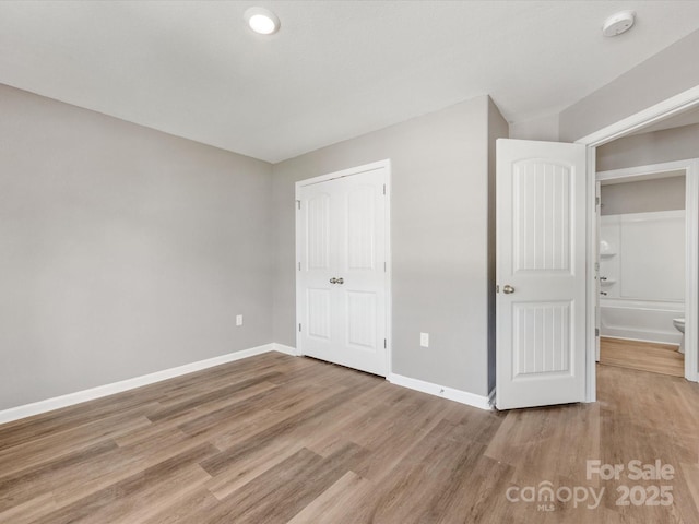 9136 Creedmore Hills Dr, Charlotte, NC 28214 - unfurnished bedroom with baseboards and wood finished floors