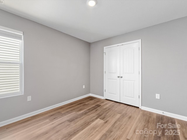 9136 Creedmore Hills Dr, Charlotte, NC 28214 - unfurnished bedroom featuring light wood finished floors and a closet