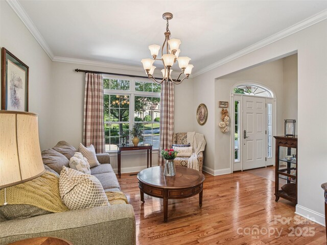 145 Fernbrook Way, Hendersonville, NC 28791 - living area with a chandelier, healthy amount of natural light, ornamental molding, and light wood finished floors
