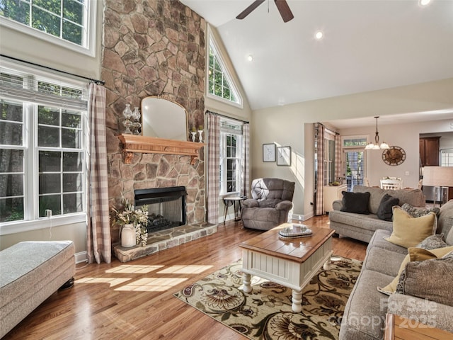 145 Fernbrook Way, Hendersonville, NC 28791 - living room featuring a ceiling fan, high vaulted ceiling, wood finished floors, a fireplace, and a chandelier