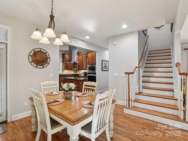 145 Fernbrook Way, Hendersonville, NC 28791 - dining area featuring light wood-type flooring, stairway, recessed lighting, and a chandelier
